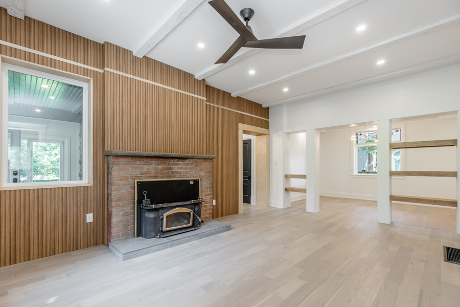Fireplace and Wood Paneling Accent Wall on a Complete Home Renovation by Landshape
